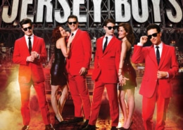 Jersey Boys. Four men in red suits and sunglasses accompanied by two doting women in black dresses. Fog effects and NYC skyline background