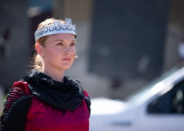 A close up of a performer dressed as a queen