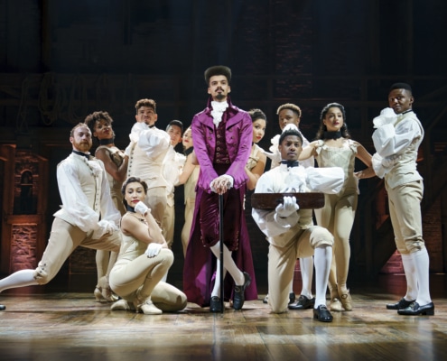 Thomas Jefferson stands surrounded by dancers onstage looking out to the audience in Hamilton Broadway National Tour