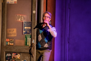 Aaron Vega playing a kazoo onstage in The Other Josh Cohen