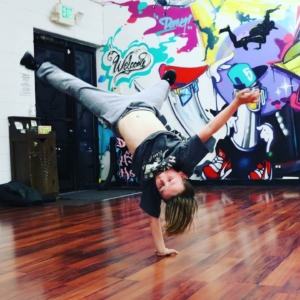 a young dancer does a handstand trick