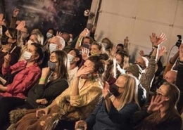 Audience sits watching a show at the Local Theater Company