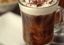 An irish coffee in a handled glass with chocolate shavings on top