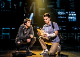 Noah Kieserman as Connor Murphy and Stephen Christopher Anthony as Evan Hansen kneel onstage