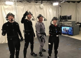 A group of actors wearing MoCap Suits pose for a photo