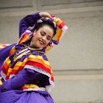 A Mexican dancer wearing a colorful costume