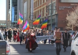 A group of students march down the street dressed in Renaissance clothing