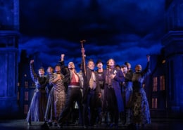 The cast of Moulin Rouge poses at the front of the stage