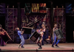 The cast of STOMP plays musical instruments onstage