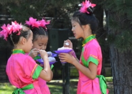 Three children enjoy shaved ice