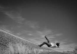 A person falling backwards of a cliff edge