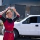 An actor places a crown on her head during a performance of Macbeth