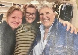 A photograph of three women smiling