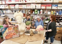 The props team stands around some of their projects