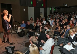 A comedian stands onstage at Comedy Works