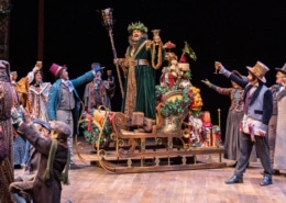 The ghost of Christmas Present raises a glass in A Christmas Carol