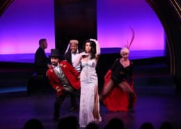 A group of actors dance dressed like Moulin Rouge characters