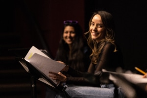 Jamie Ann Romero smiles onstage during Cebollas rehearsal