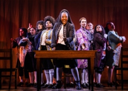 The cast of 1776 stands onstage as they sing