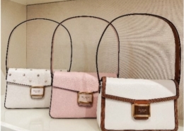 Purses lined up on a shelf in Kate Spade