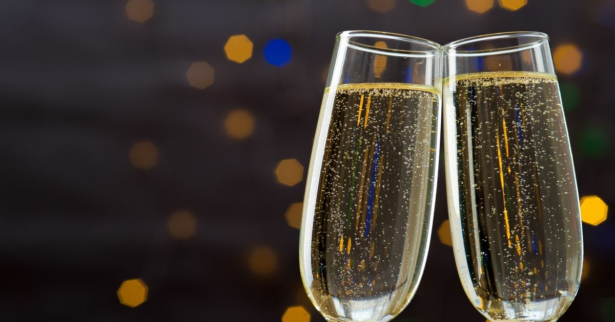 Champagne glasses toasting against a glittering background
