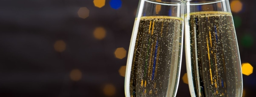Champagne glasses toasting against a glittering background