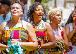 Women wearing traditional African garments stand together during the Colorado Black Arts Festival