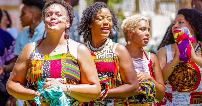 Women wearing traditional African garments stand together during the Colorado Black Arts Festival