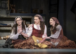 Chava, Tzeitel, and Hodel sit on the floor together in Fiddler on the Roof