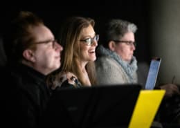 Sandy Rustin smiles as she watches The Suffragette's Murder in rehearsal