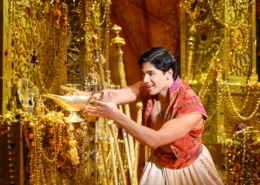 Aladdin reaches for the magic lamp in the underground treasure trove, the Cave of Wonders