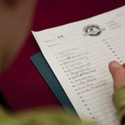 A child writes words on a worksheet at the Colorado State Spelling Bee