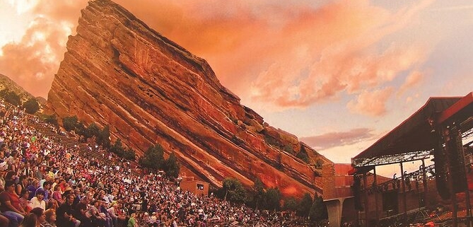 Thousands of people sit at Red Rocks