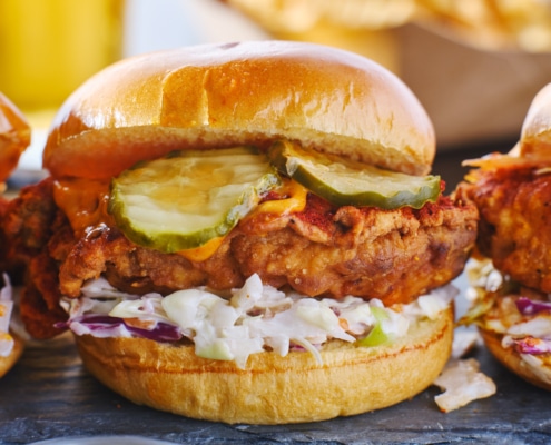 Three Nashville hot chicken sandwiches lined up for their beauty shot