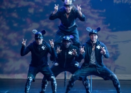 Dancers dressed as mice form a pyramid