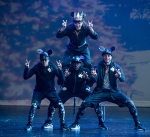 Dancers dressed as mice form a pyramid