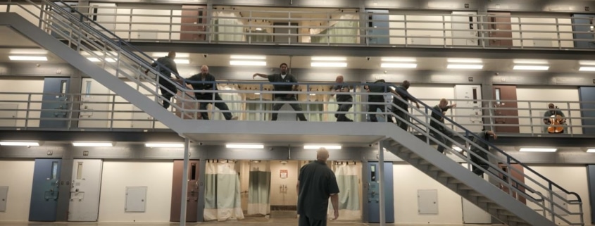 Prisoners perform along a stairway in the prison