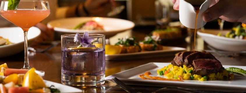 A table filled with brunch delights and cocktails.